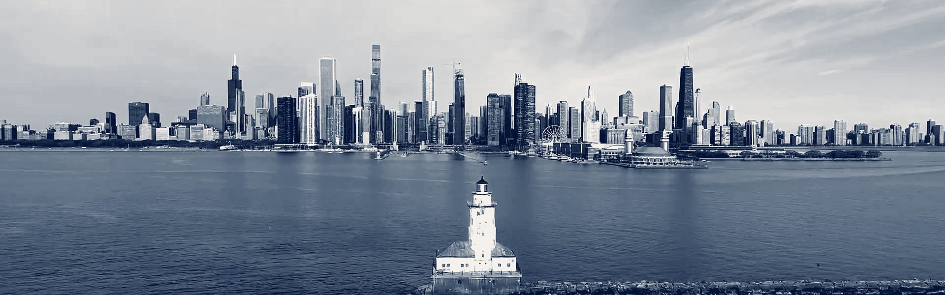 The Chicago skyline seen across the lake, with the harbor lighthouse in front