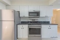 White kitchen with stainless steel appliances