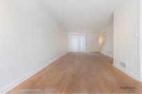 Empty living room with wood laminate floors